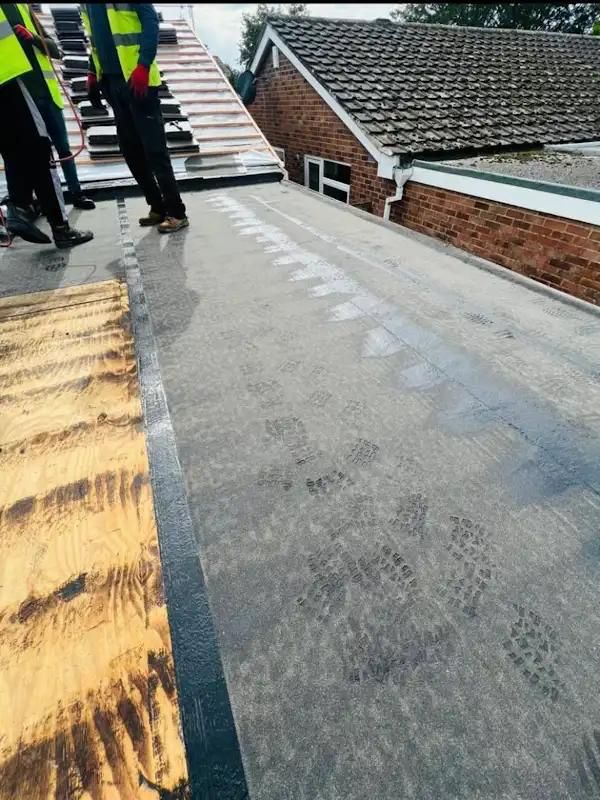 Newly installed black EPDM flat roof on a single-storey extension in Hertfordshire