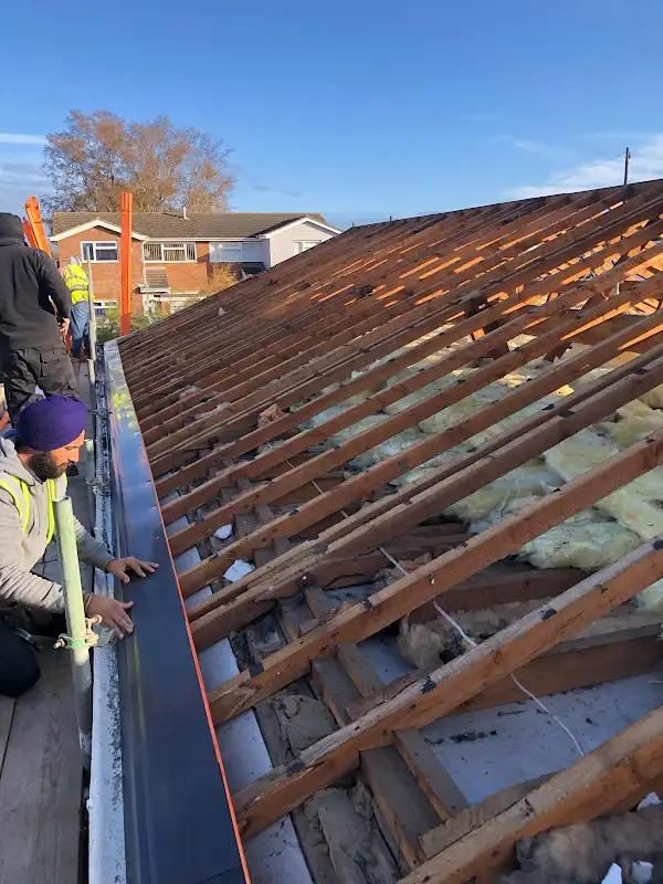Roof repair work in progress — replacing slipped tiles on a Hertfordshire pitched roof